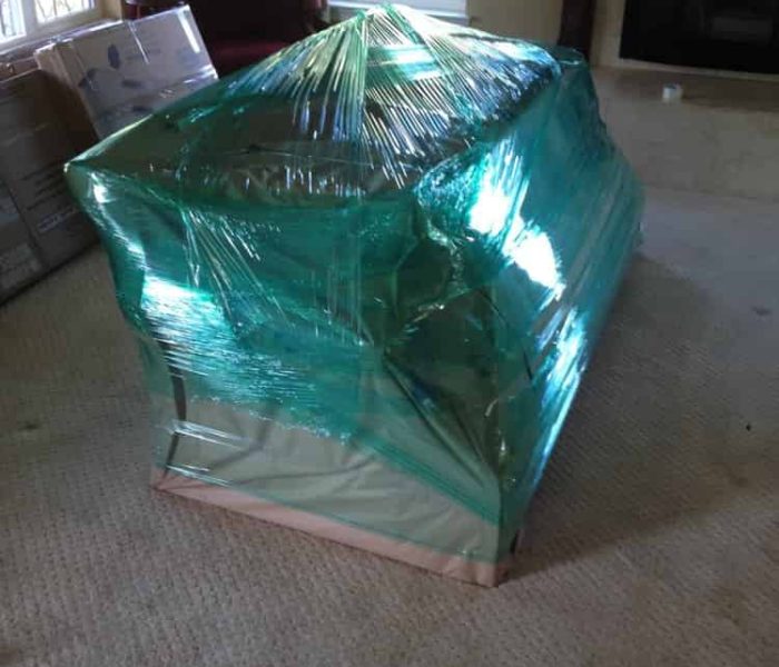 Couch is shrink wrapped and paper padded for an international move.