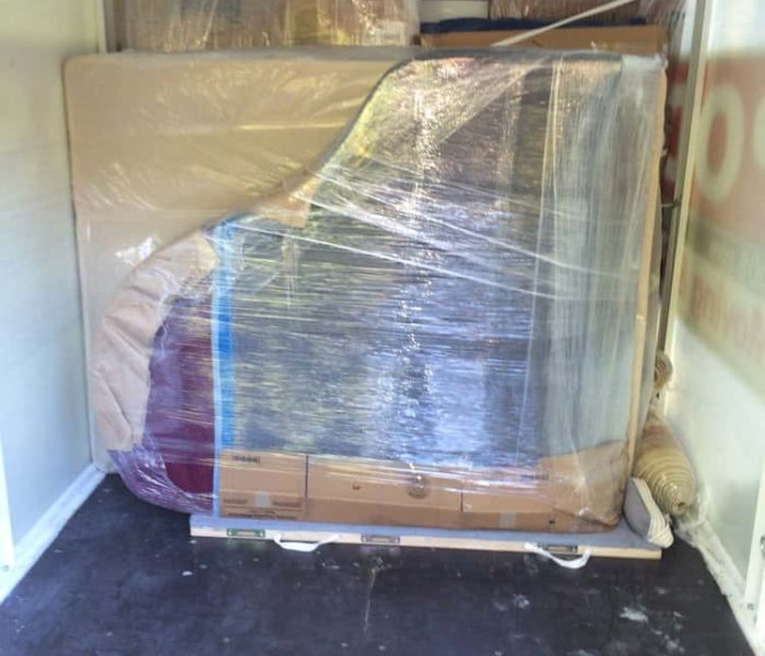 Baby Grand properly loaded into a POD for Transportation cross country.